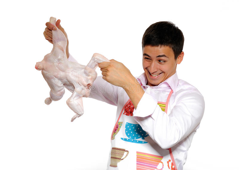 de-knappe-het-koken-kip-van-de-jonge-mensenholding-16215064.jpg